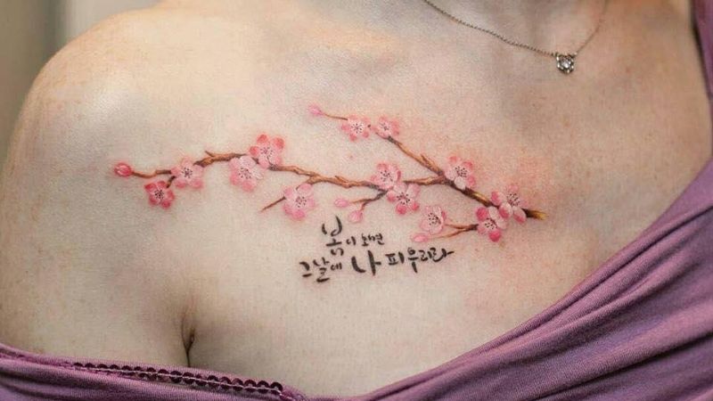 Hình xăm hoa anh đào cùng những kí hiệu chữ đặc biệt.